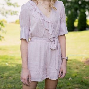 Pink romper with ruffle and tie waist